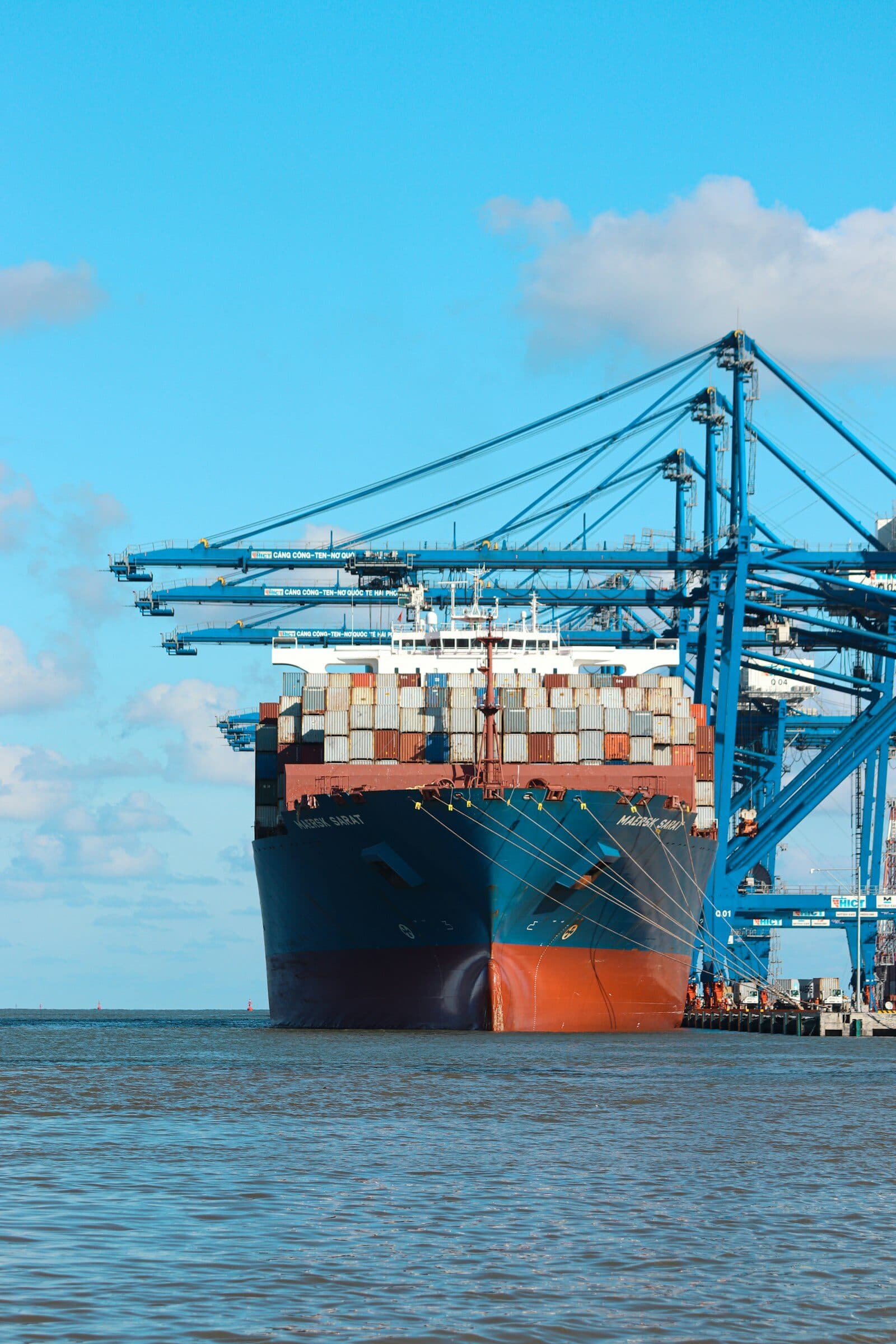 Container ship docked at port with shipping containers